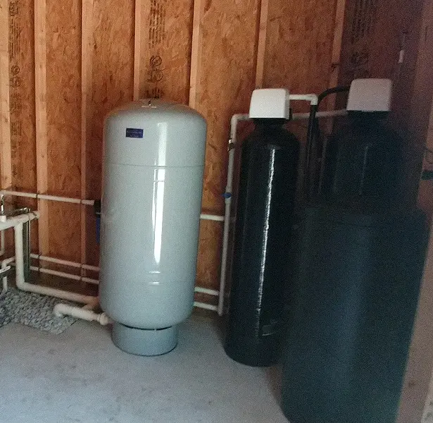 image 1 Two water softeners in a room next to each other.
