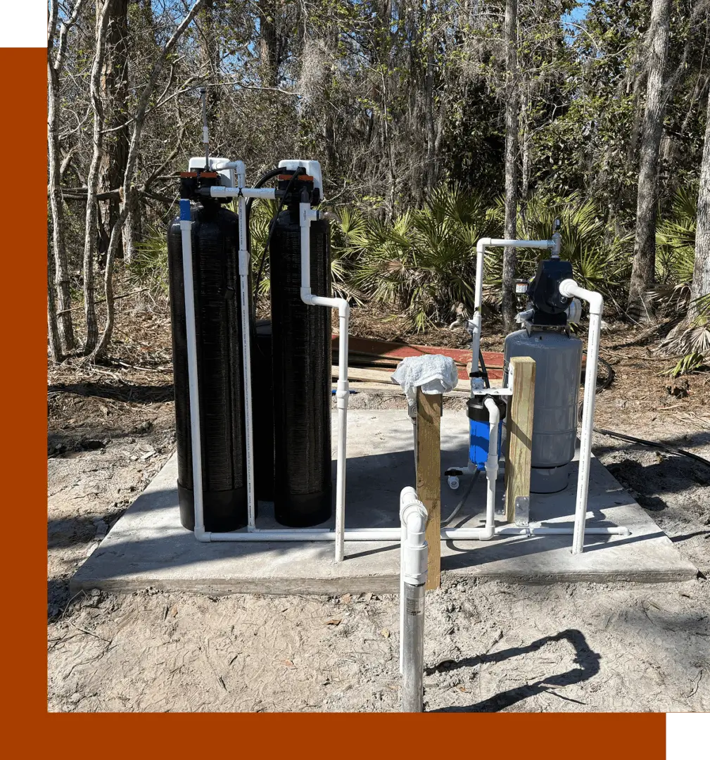 A couple of water tanks sitting on top of a dirt field.