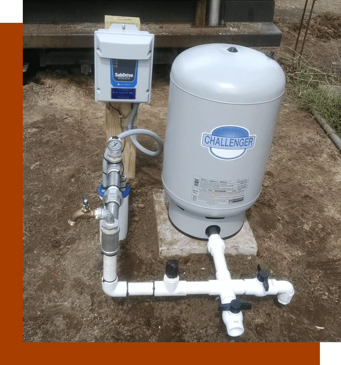 A water heater and pump in the dirt.